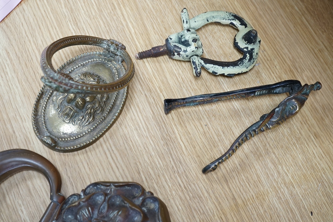 A group of four various cast brass door knockers. Condition- fair to good
